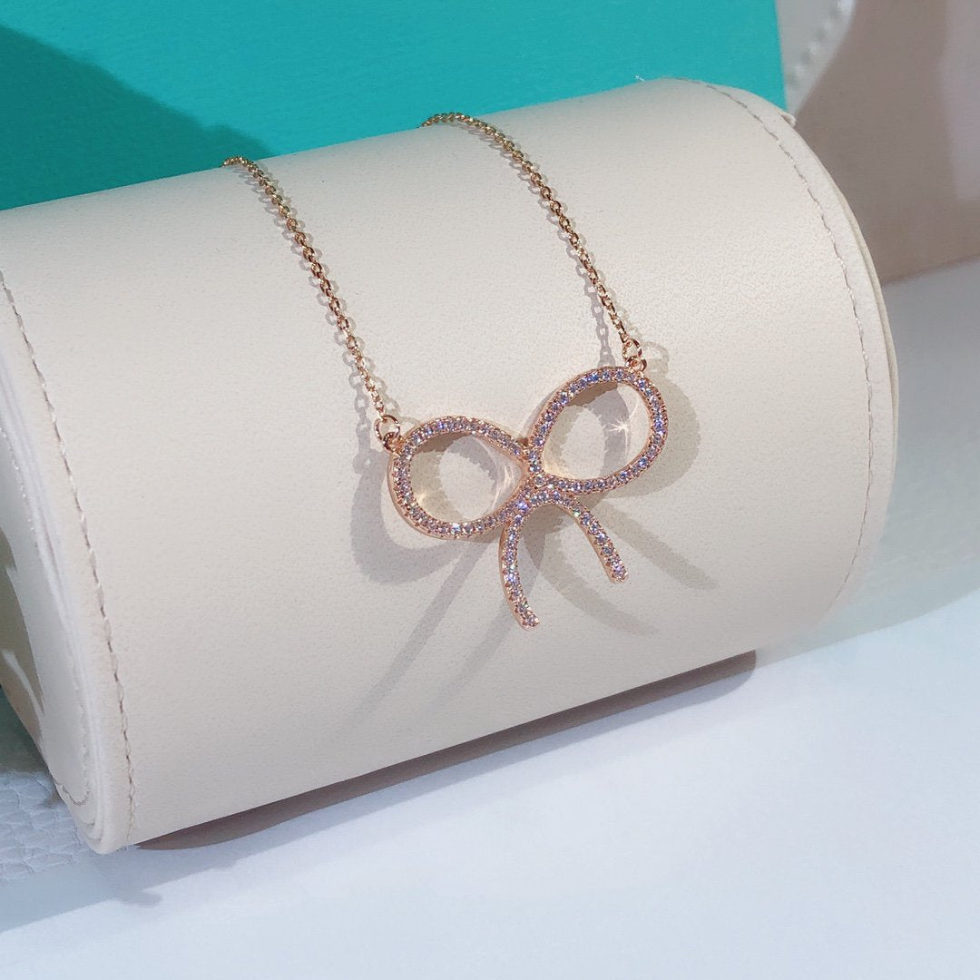 TIFFANY CLAW SET RHODIUM PLATED BOW NECKLACE