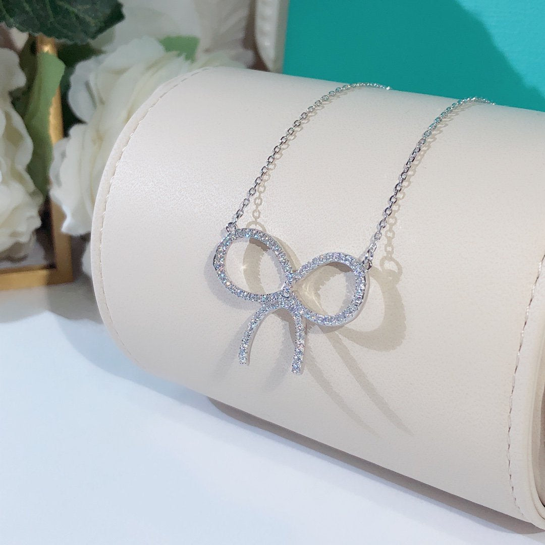 TIFFANY CLAW SET RHODIUM PLATED BOW NECKLACE